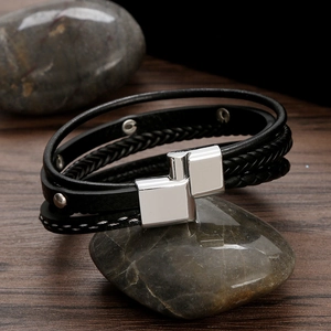 Multi-layer black braided leather bracelet with silver studs and geometric metal clasp
