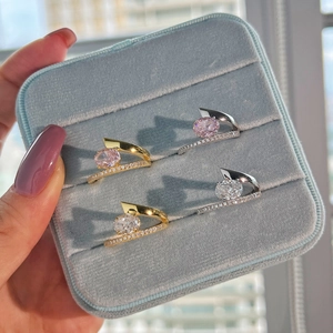 Detail of S925 silver rings with pink and clear cubic zirconia in a velvet box