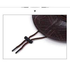 Detail view of brown western cowboy hat featuring leaf texture brim and adjustable chin strap