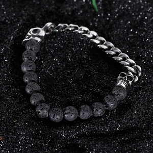 Close-up of black volcanic stone beads and silver skull charms on punk style bracelet