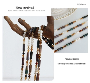 Detail of handmade necklace featuring natural tiger eye stone and freshwater pearls
