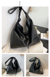 Detail of black large capacity hobo bag with unique knotted strap and soft PU leather