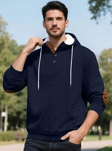 Détail d'un sweat à capuche en maille gaufrée marine avec empiècements marron contrastés