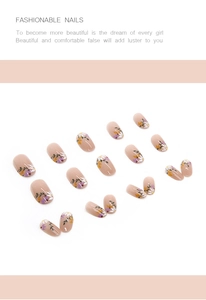 Close-up of floral press-on nails with hand-painted patterns on nude base finish