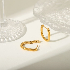 Minimalist gold-plated stainless steel U-shaped hoop earrings on elegant background