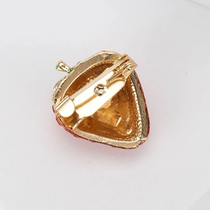 Fashion alloy strawberry brooch with red enamel and gold pin backing on white background