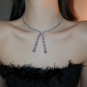 Close-up of sparkling zircon drop pendant on an adjustable silver-tone Y-necklace choker