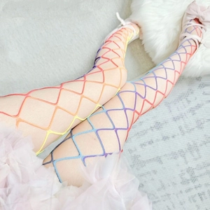 Close-up of rainbow gradient fishnet stockings with large mesh and sparkling rhinestones