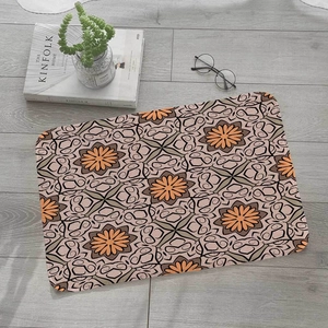 Close-up of bohemian mandala pattern on flannel floor mat over grey wooden floor