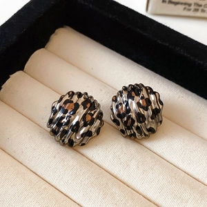 Detail showing the ripple texture and leopard print on these silver hoop earrings