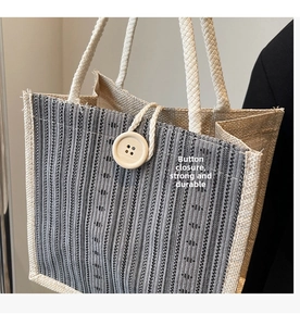 Close-up of linen tote bag featuring a large wooden button and loop closure detail