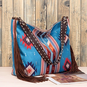 Detail of bohemian jacquard fabric tote with blue patterns and brown leather straps