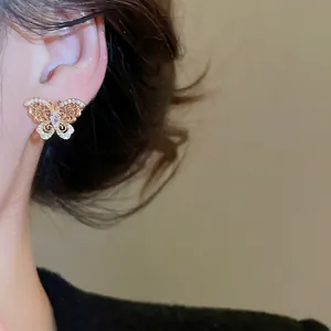 Exquisite gold-plated butterfly stud earrings with micro-set zircon on model