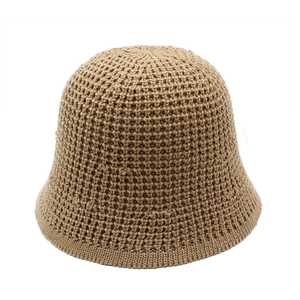 Close-up detail of khaki crochet sun hat showing the hollow honeycomb knit texture and pattern