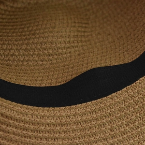 Close-up of the natural straw weave texture and black inner sweatband of the fedora hat