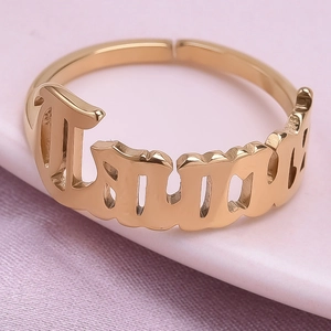 Macro shot of gold-plated Taurus zodiac ring with Gothic lettering and adjustable band