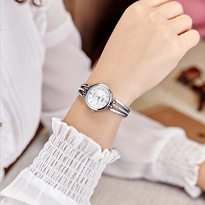 Elegant silver women's watch with rhinestones on steel band worn by a model