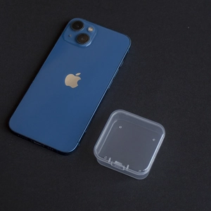 Size comparison of small square clear PP plastic organizer box next to a smartphone