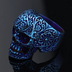 Close-up of engraved skull ring with blue-purple gradient plating on dark background