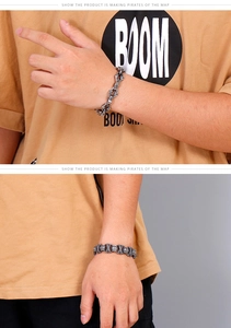 Close-up of vintage stainless steel cross bracelets on wrist with punk silver finish