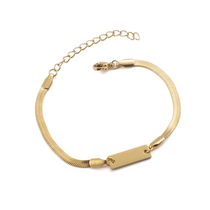 Detail of a gold herringbone snake chain bracelet with a polished engravable ID bar plate