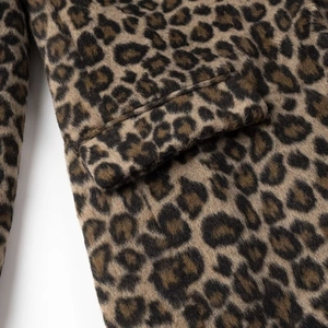 Detailed view of leopard print blazer showing sleeve cuffs and pocket texture on wool fabric