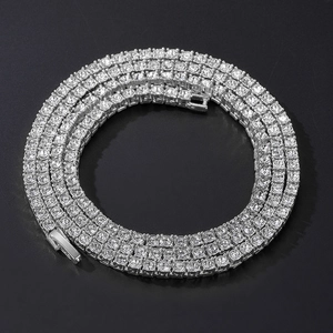 Detailed top view of silver tennis chain with sparkling rhinestones on black background