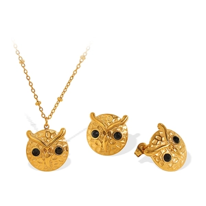 Exquisite gold owl jewelry set with necklace and earrings featuring black crystal accents
