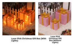 Detail of pink laser Christmas gift boxes with gold bows showing LED light effects