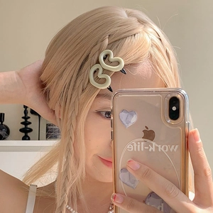 Pink heart hair clip worn on blonde braided hair for a sweet and minimalist style