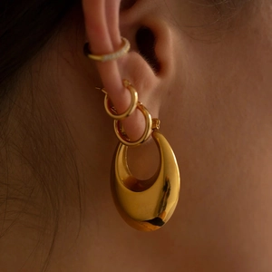 Polished 18K gold chunky hollow hoop earrings and ear cuff set shown on model