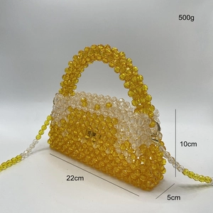 Detail view of yellow and clear beaded handbag with dimensions 22x10x5cm and strap