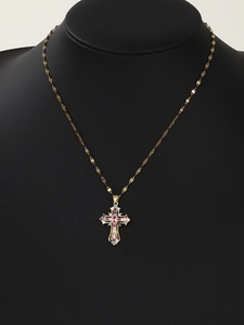 Detailed view of golden cross pendant with colorful micro-set zircons on black mannequin