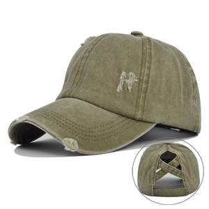 Detailed view of army green distressed baseball cap with criss-cross ponytail opening