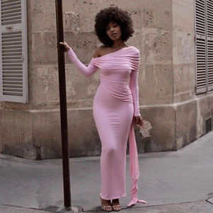 Detail view of pink one-shoulder dress with elegant pleats and decorative ribbon