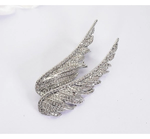 Detail view of silver angel wings brooch with shimmering micro-pave crystals