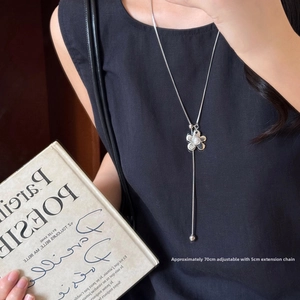 Detail of adjustable silver Y-necklace with flower charm and pearl on 70cm chain
