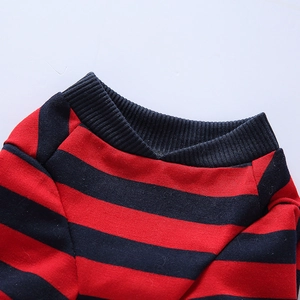 Close-up of red and navy striped dog pajamas showing ribbed neckline and fine knit texture