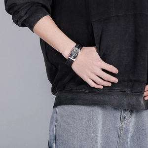 Men's braided leather bracelet with silver eagle engraved metal charm on wrist