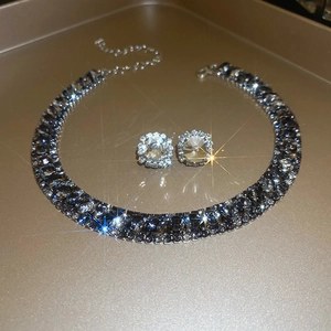 Sparkling square zircon necklace and stud earrings set displayed on a gold tray