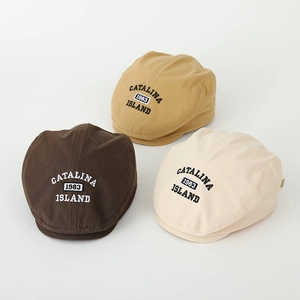 Detailed view of kids vintage 1983 letter embroidery on beige and brown beret caps