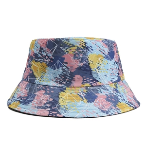 Detailed view of bucket hat featuring colorful abstract graffiti and white geometric lines