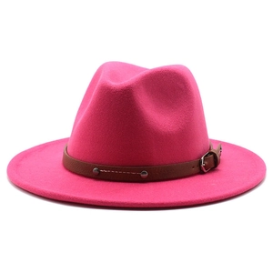 Close-up of rose red wool fedora with brown leather band and silver buckle detail