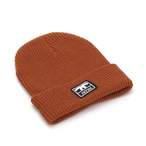 Detailed view of caramel ribbed knit beanie with rectangular JXTXH embroidery label