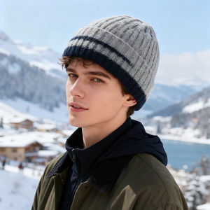Winter thermal knit beanie hat for men in navy and grey against a snowy mountain backdrop