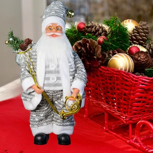 Detail of silver-grey Santa Claus figurine holding a golden horn with festive red basket