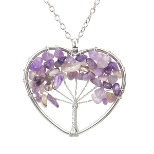 Detailed view of handmade heart-shaped tree of life pendant with purple amethyst crystals