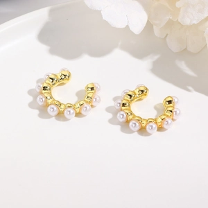 Elegant gold-plated C-shaped ear cuffs with white faux pearls on minimalist white background