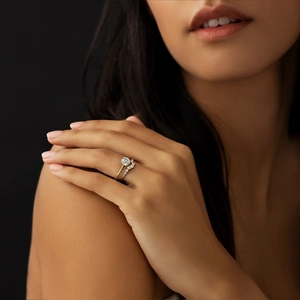 Close-up of luxury wavy pave diamond ring worn on hand during a formal evening event
