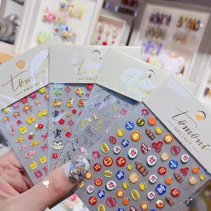 Close-up of 5D embossed nail stickers with tiger, fortune characters and lucky symbols